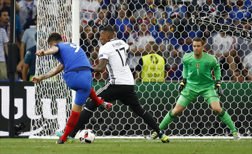 Germany's Jerome Boateng blocks a shot from France's Olivier Giroud as Germany's Manuel Neuer looks on. Picture credits: Reuters