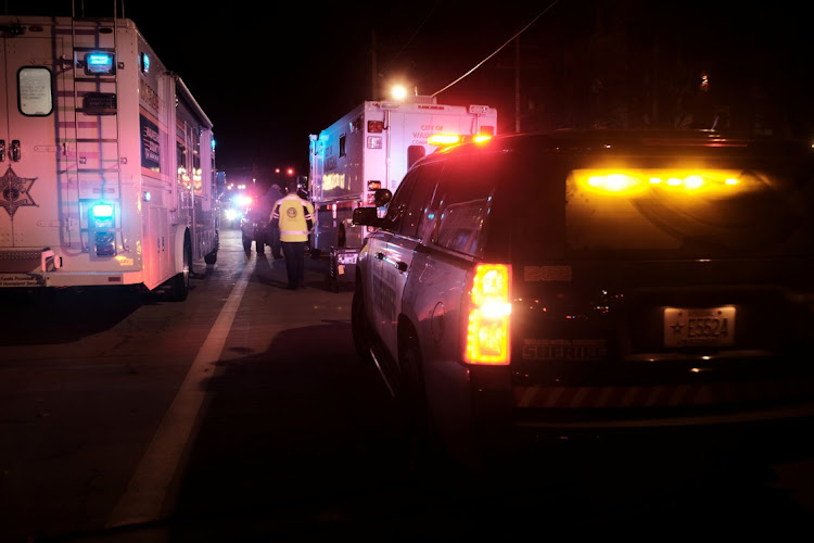 Emergency personnel tend to victims after a car plowed through a holiday parade in Waukesha, Wisconsin, the US, on November 21 2021. Picture: REUTERS/DANIEL STEINLE