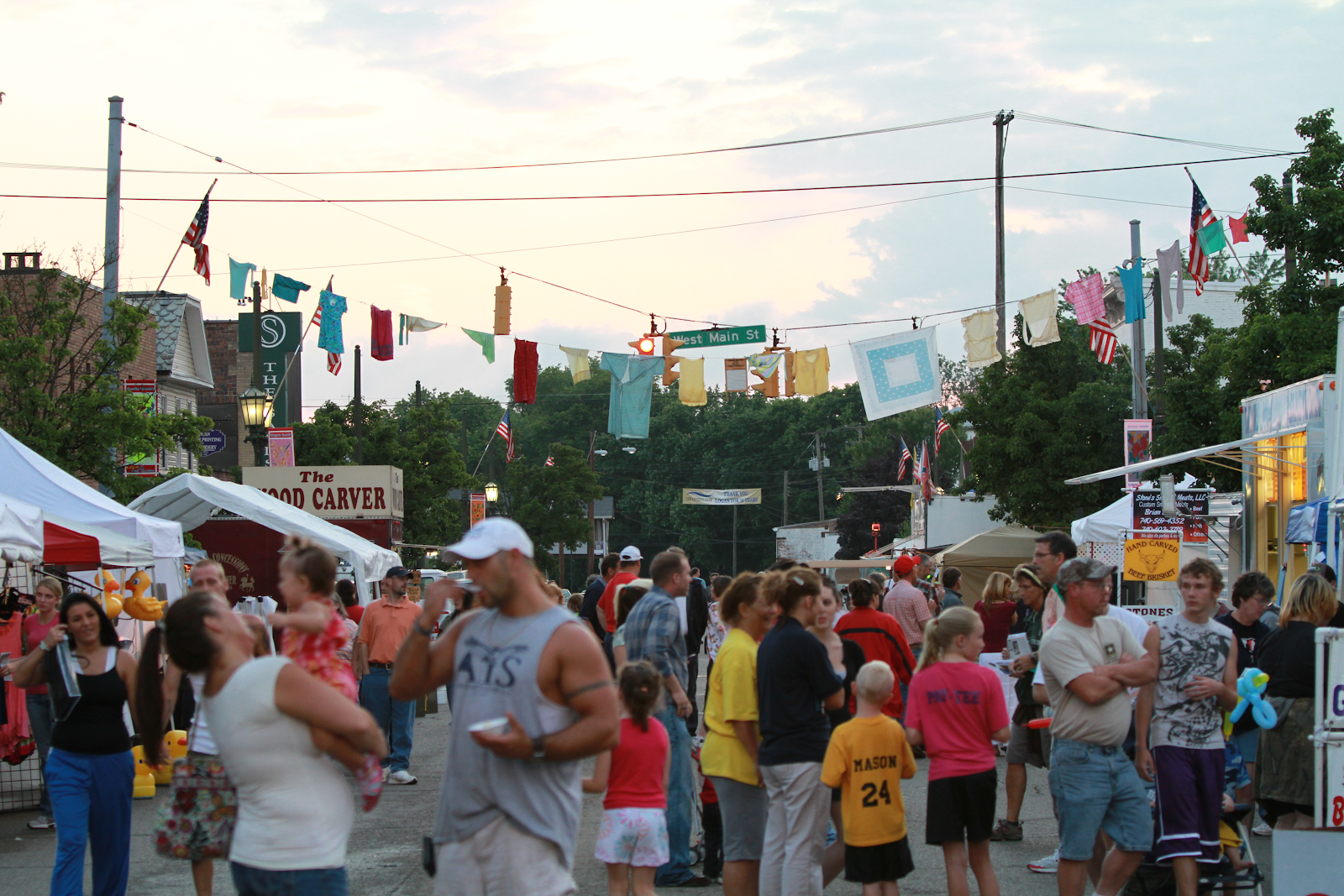 a crowd of people in the streets during a festival