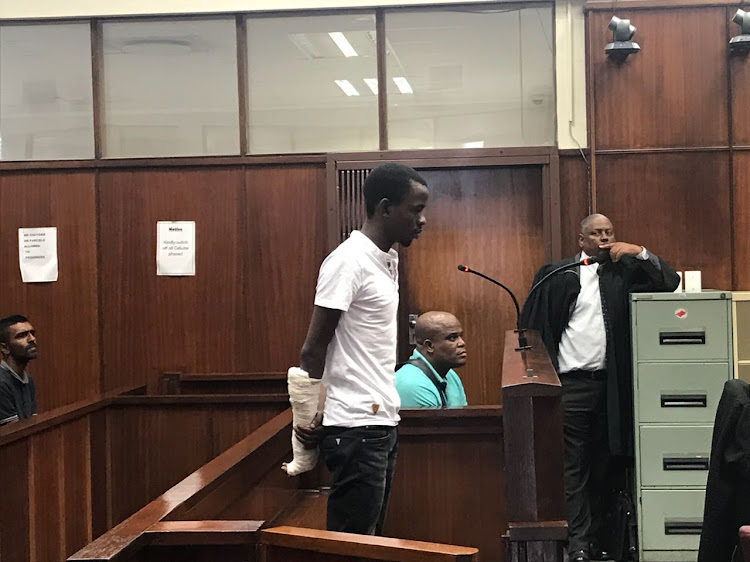 Sphamandla Buthelezi stands in the dock in the Durban Magistrate's Court on June 20, 2018, where he is charged with the murder of Kelly Chetting in a botched hijacking.