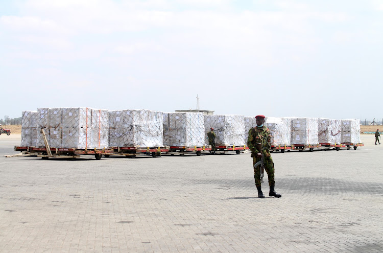 A GSU officer guards pallets containing presidential ballot materials at JKIA cargo centre on Wednesday, July 27.