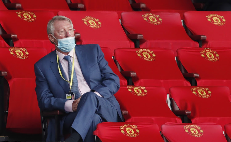 Sir Alex Ferguson watches on from the stands wearing a protective face mask before the Premier League match between Manchester United and Southampton at Old Trafford on July 13, 2020.