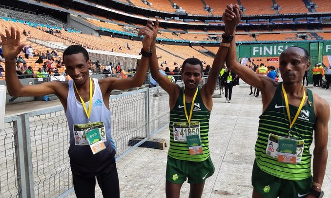 The Soweto Marathon podium finishers in the men's 42km race - winner Daba Ifa Debele (centre), second-placed Gadisa Bekele Gutama (right) and third-placed Tsepo Ramashamola (left) at the finish at FNB Stadium on November 6.