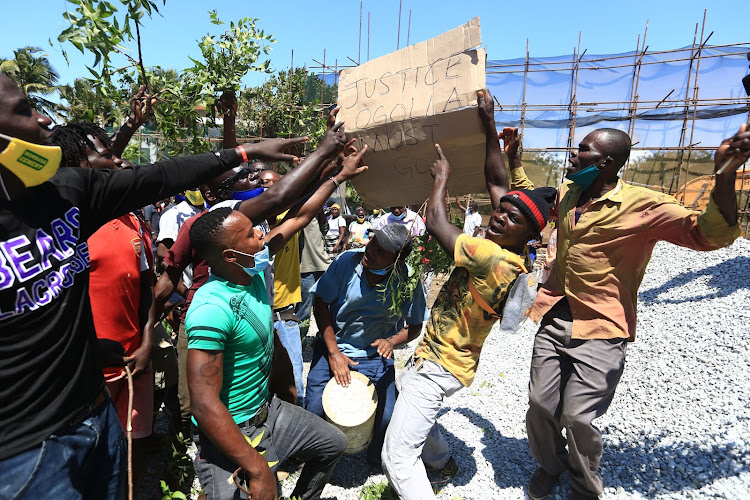 Workers protest Judge Eric Ogola's ruling that stopped work at the construction site in Nyali on Friday.