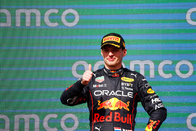 Max Verstappen celebrates on the podium after winning the US F1 Grand Prix at Circuit of The Americas on October 23 2022 in Austin, Texas.