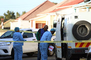 Police investigate the scene after a heist in East London. 