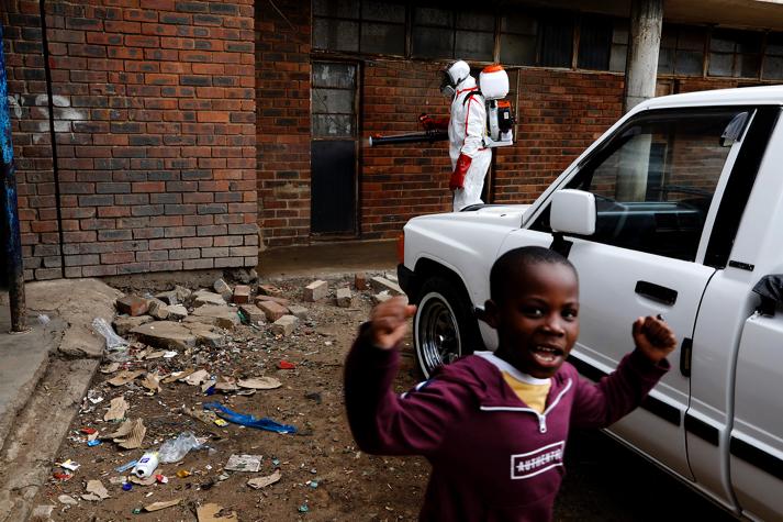 Members of the health services go about their work disinfecting the Madala hostel in Alexandra, Johannesburg, amid efforts to control the Covid-19 pandemic.