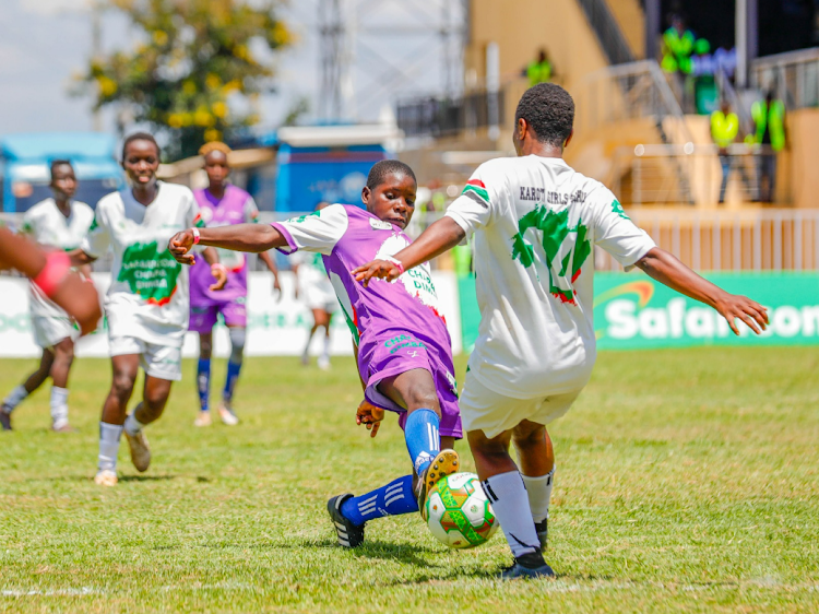 Barcelona ladies (purple) in a match against Kartsville FC (White) during the Safaricom Chapa DimbaCentral Region final held at Wang'uru stadium, Kirinyaga.