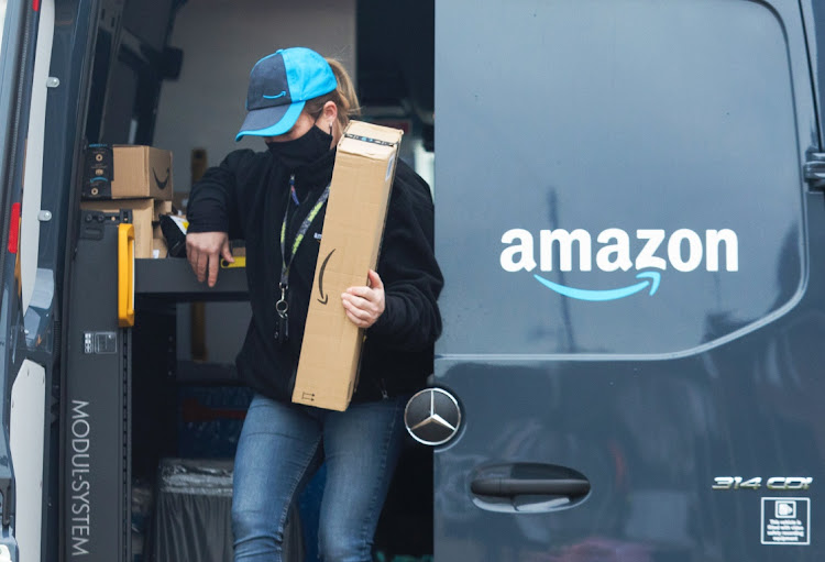 An Amazon.com delivery driver takes an order from a delivery van in Westcliff-on-Sea, the UK, November 26 2020. Picture: CHRIS RATCLIFFE/BLOOMBERG