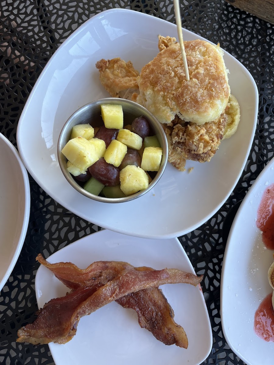 Winchester Fried Chicken and Biscuit Sandwich w/ fruit and bacon