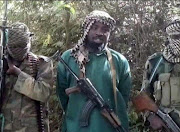 A picture taken from a video distributed to Nigerian journalists in the country's north in recent days through intermediaries and obtained by AFP on March 5, 2013 shows Abubakar Shekau (C), the leader of Nigerian Islamist extremist group Boko Haram, flanked by two armed and hooded fighters in an undisclosed place.