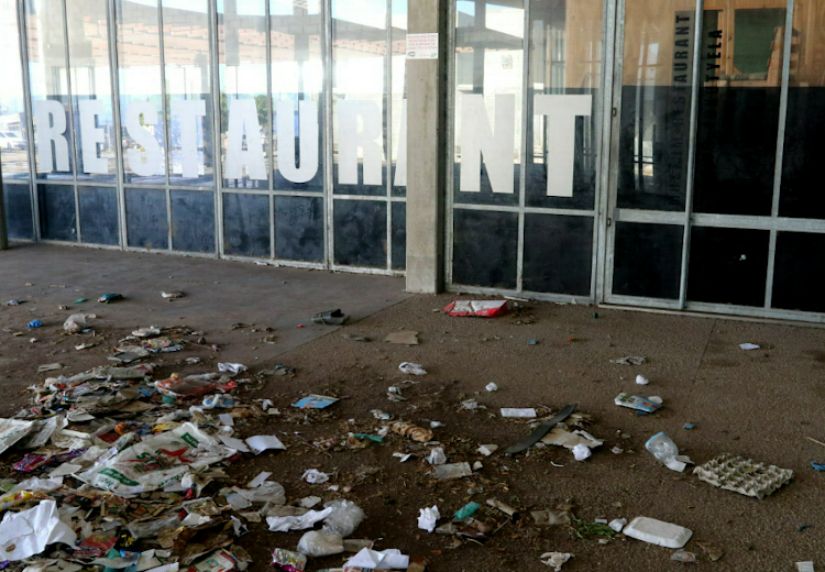 Litter lies strewn outside the restaurant at the Red Location Museum