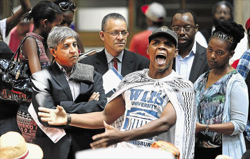 SA Students Congress president Mcebo Freedom Dlamini shouts out to fellow protesters at Wits University. Image by: Alon Skuy