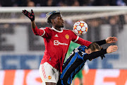 Paul Pogba of Manchester United (left) battles for the ball with Teun Koopmeiners of Atalanta in the Uefa Champions League group F match at Stadio di Bergamo  in Bergamo, Italy on November 2 2021.