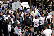 King Misuzulu KaZwelithini takes part in the men's walk with minister of social development Lindiwe Zulu.