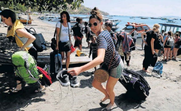 Foreign tourists leave Gili Trawangan island after an earthquake hit Lombok island in Pemenang, Indonesia