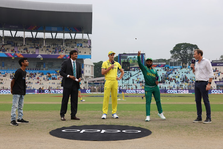 Australia captain Pat Cummins and Proteas counterpart Temba Bavuma take part in the coin toss alongside match referee Javagal Srinath (second left) ahead of the 2023 Cricket World Cup semifinal at Eden Gardens in Kolkata, India on Thursday.