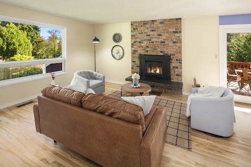Living room with leather sofa and brick fireplace - Luxury property for sale in Vashon, 3 bedrooms