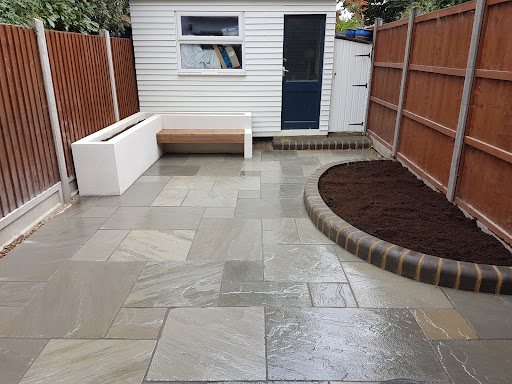 Kandla grey sandstone paving, charcoal bullnose flower bed, rendered flower bed with built in bench 
