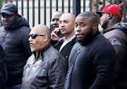 Nafiz Modack (holding a cellphone) outside the magistrate's court in Cape Town after an earlier appearance.