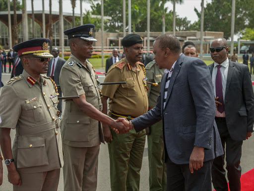 President Uhuru Kenyatta greets the new Deputy Inspector General, Kenya Police Edward Mbugua shortly before departing for South Africa on an official visit. /PSCU