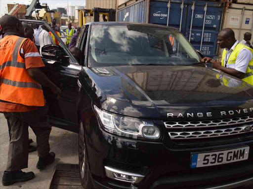 KRA officials inspect a Range Rover at the Mombasa port yesterday. Two Range Rovers imported from the UK were allegedly declared as cheap cars and bicycles /JOHN CHESOLI