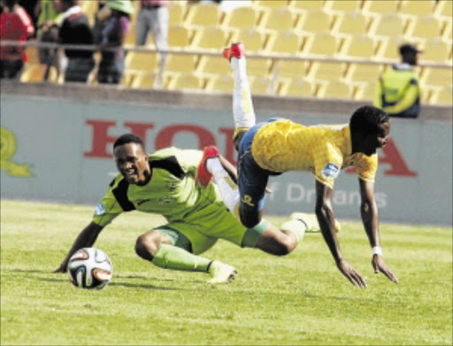 DOWN AND OUT: Platinum Stars defender Luvolwethu Mpeta, left, upends Mamelodi Sundowns' Elias Pelembe during yesterday's Telkom Knockout semifinal at Royal Bafokeng Stadium in Phokeng. Stars won 1-0 PHOTO: ANTONIO MUCHAVE