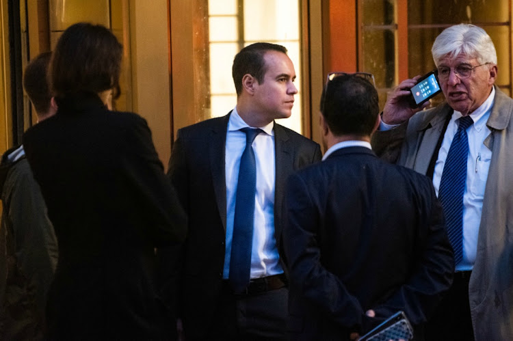 Bryan Cohen, an investment banker for Goldman Sachs, centre, and attorney Ira Sorkin, right, depart from federal court in New York, on Tuesday October 22 2019. Cohen was arrested Friday over allegations of insider trading, court records show. Picture: BLOOMBERG/MARK KAUZLARICH