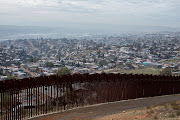 Tijuana, Mexico is pictured behind one of the primary border walls between Mexico and the US. The massacre caused renewed consternation in Mexico about perils faced by migrants.