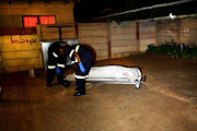  Forensic officers wrap and collect the body of an elderly grandmother.