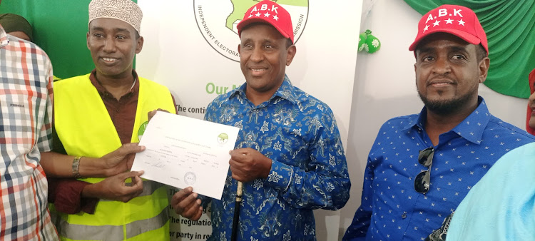 Garissa Governor Ali Korane holds his certificate after being cleared by IEBC on Saturday