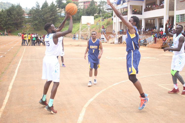 Andrew Sunda of Kisii Raptors goes for a basket as Mustang's Emmanuel Kelechi attempts to block him