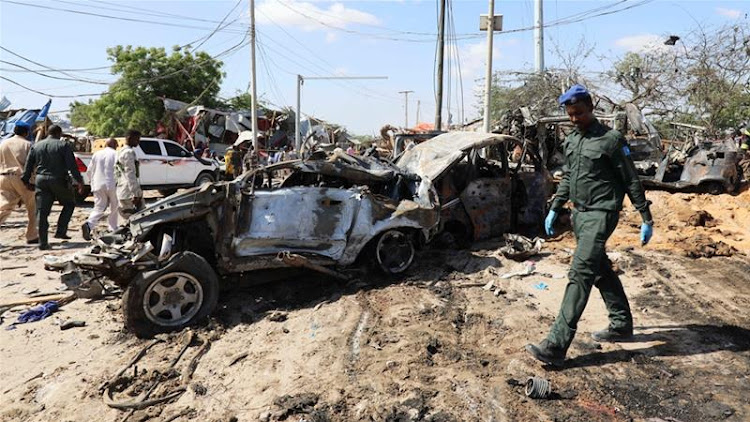 A security officer at the scene of the car bomb explosion in Mogadishu on Saturday