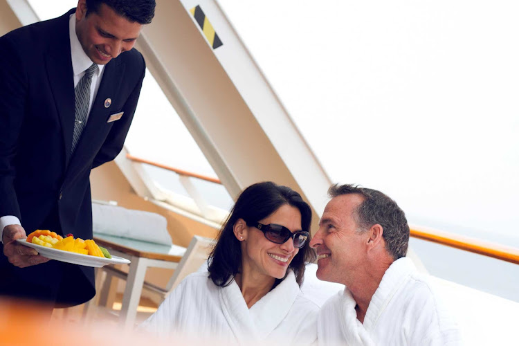 A butler serves Champagne to a couple during a sailing in Asia on Azamara Club Cruises.