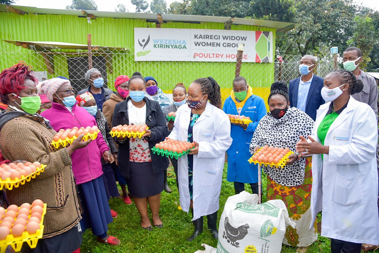 Kirinyaga Governor Anne Waiguru with members of a woman's group supported by the county government to produce eggs. The project is aimed at increasing farmers' incomes as well as improving the nutritional status of the county.