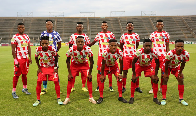 Mathaithai FC players line up for a team picture before the match.