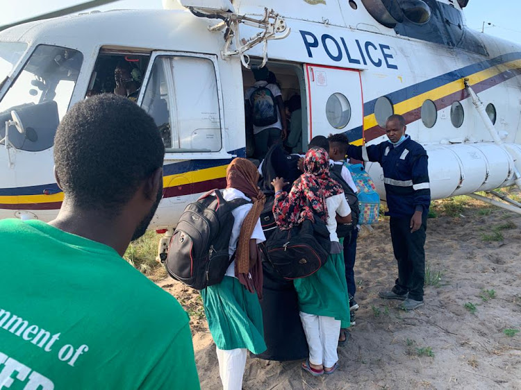 Teachers and learners disembark from a police chopper in Boni, Lamu county last year.