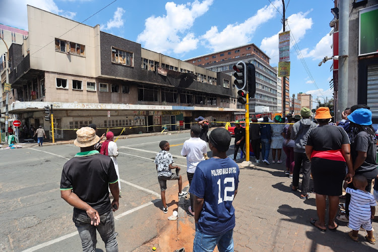 JA fire engulfed a building on Commissioner Street in Johannesburg yesterday. The city's emergency services were dispatched to extinguish the fire and found four people injured and two dead.
