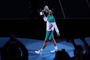 Serbia's Novak Djokovic celebrates with the trophy after winning his final match against Russia's Daniil Medvedev.