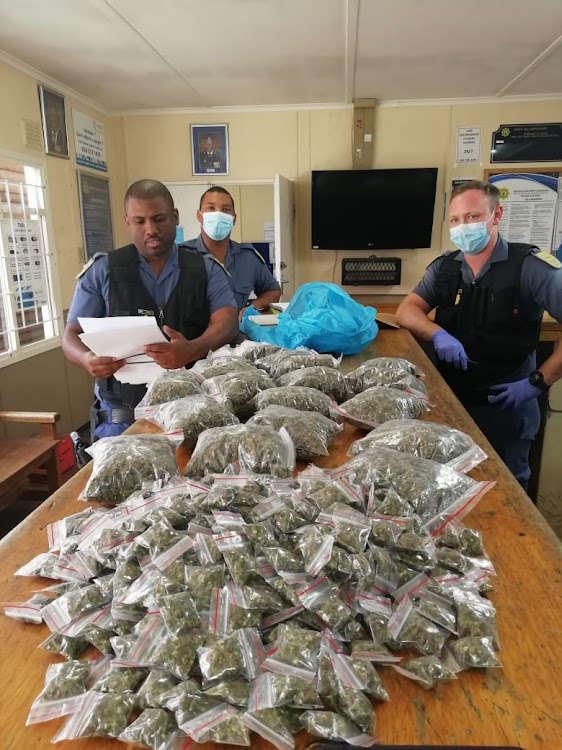 Villiersdorp police pose with a 3.64kg consignment of dagga confiscated at a roadblock near Grabouw on Monday.