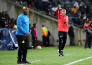 Orlando Pirates' head coach Milutin Sredojevic reacts on the touchline alongside his Mamelodi Sundowns' counterpart Pitso Mosimane on April 1 2019. 