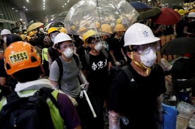 Anti-extradition bill protesters wearing helmets gather outside the legislative council building on the anniversary of Hong Kong's handover to China in Hong Kong, China, on July 1 2019.