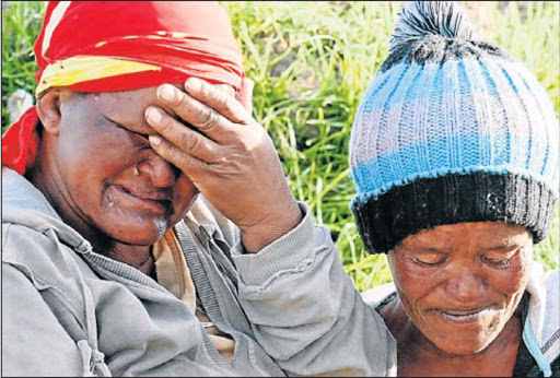 SHARED GRIEF: The drowned children’s mothers‚ Magrette Makonie‚ left‚ and Virginia Botha‚ weep after the drowning of little Jaydene Makonie and Patriano Botha in the Langkloof. Picture: FREDLIN ADRIAAN