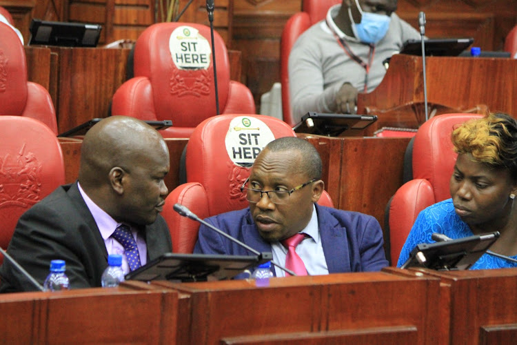 IEBC Legal director Chrispine Owiye (L) confers with deputy Parties Registrar Ali Abdulahi during a meeting by JLAC on amendments to the Elections Act, 2011, Tuesday, March 15.