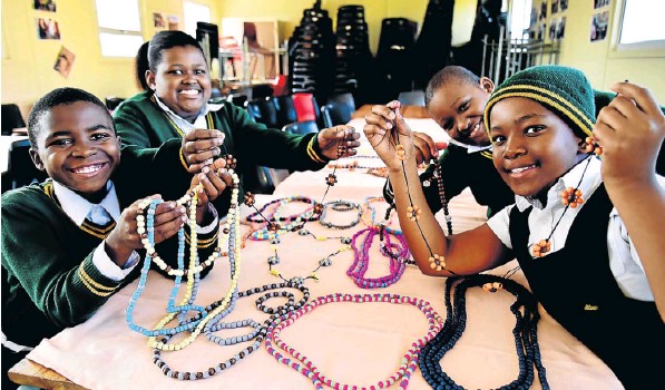 Charles Duna Primary pupils, from left, Chumani Jwara, 9, Siyolise Mpofu 11, Siphamandla Mpofu, 9, and Ongeziwe Vuta, 10, make jewellery in their spare time to sell at the market