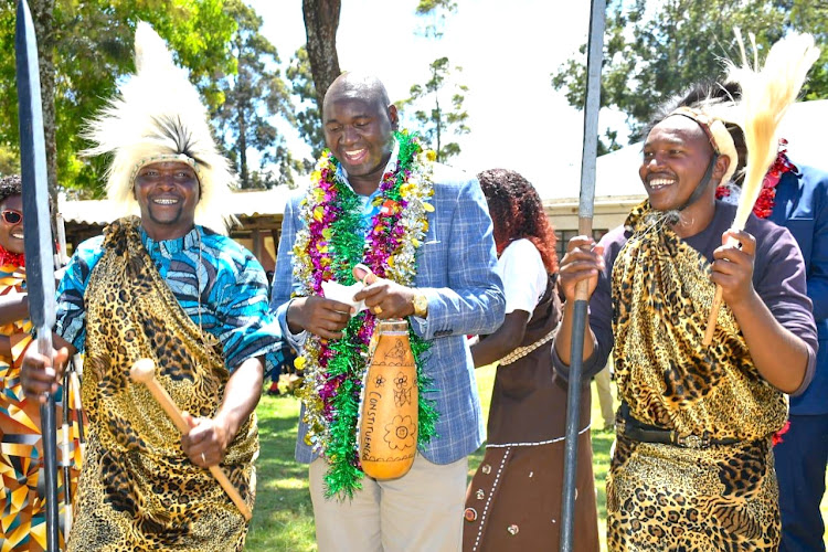 Immigration PS Julius Bitok with entertainers during the opening of the Civil Registration Office in Moiben, Uasin Gishu constituency on May 17, 2024.