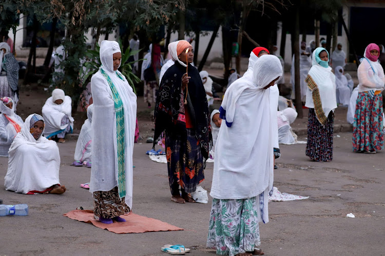 Ethiopian Orthodox faithful practice social distancing as they attend a morning prayer session at the St. Michael church, amid concerns about the spread of coronavirus disease (COVID-19), in Addis Ababa, Ethiopia, April 1, 2020.