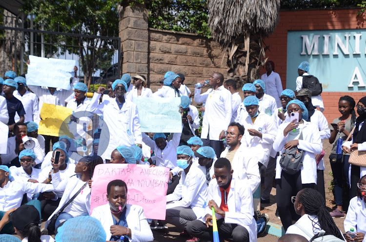 Graduate medical students with placards, whistles and vuvuzelas outside Afya House as they protest over delays by the Ministry of Health in posting them for internship on February 12, 2024