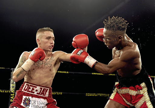 DeeJay Kriel, left, in a fight against Xolisa Magusha. On Sunday Kriel faces Carlos Licona in US for IBF mini-flyweight title. /Gallo Images