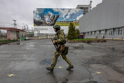 A Ukrainian army soldier patrols outside the Chernobyl Nuclear Power Plant on April 26, 2022 in Chernobyl, Ukraine.  